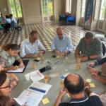 En table ronde, les membres rédigent des idées individuellement